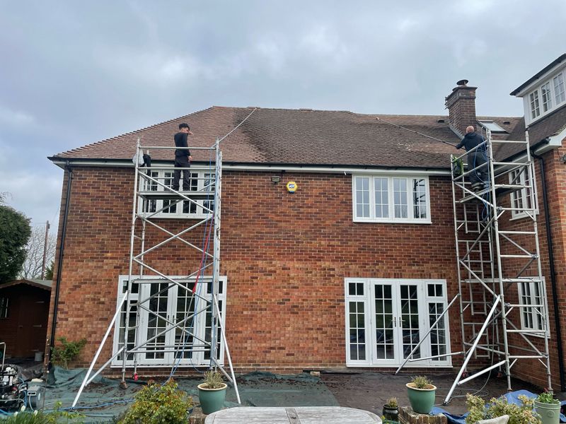 Roof cleaning carried out safely from scaffold towers by The Roof Moss Cleaners in Oundle